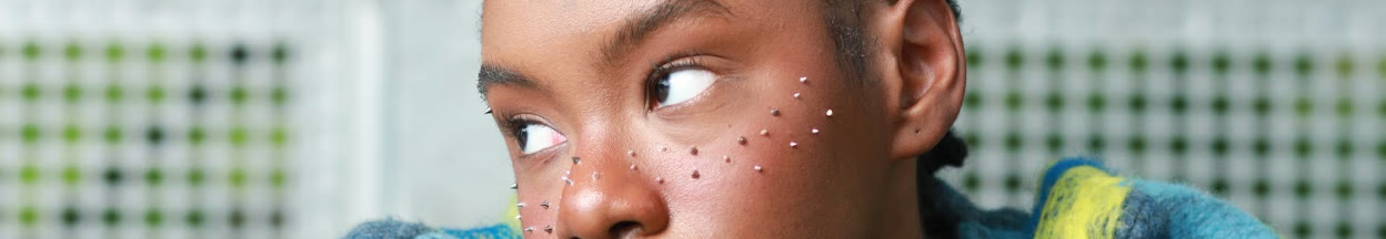 Editorial photograph — close crop of a model's face