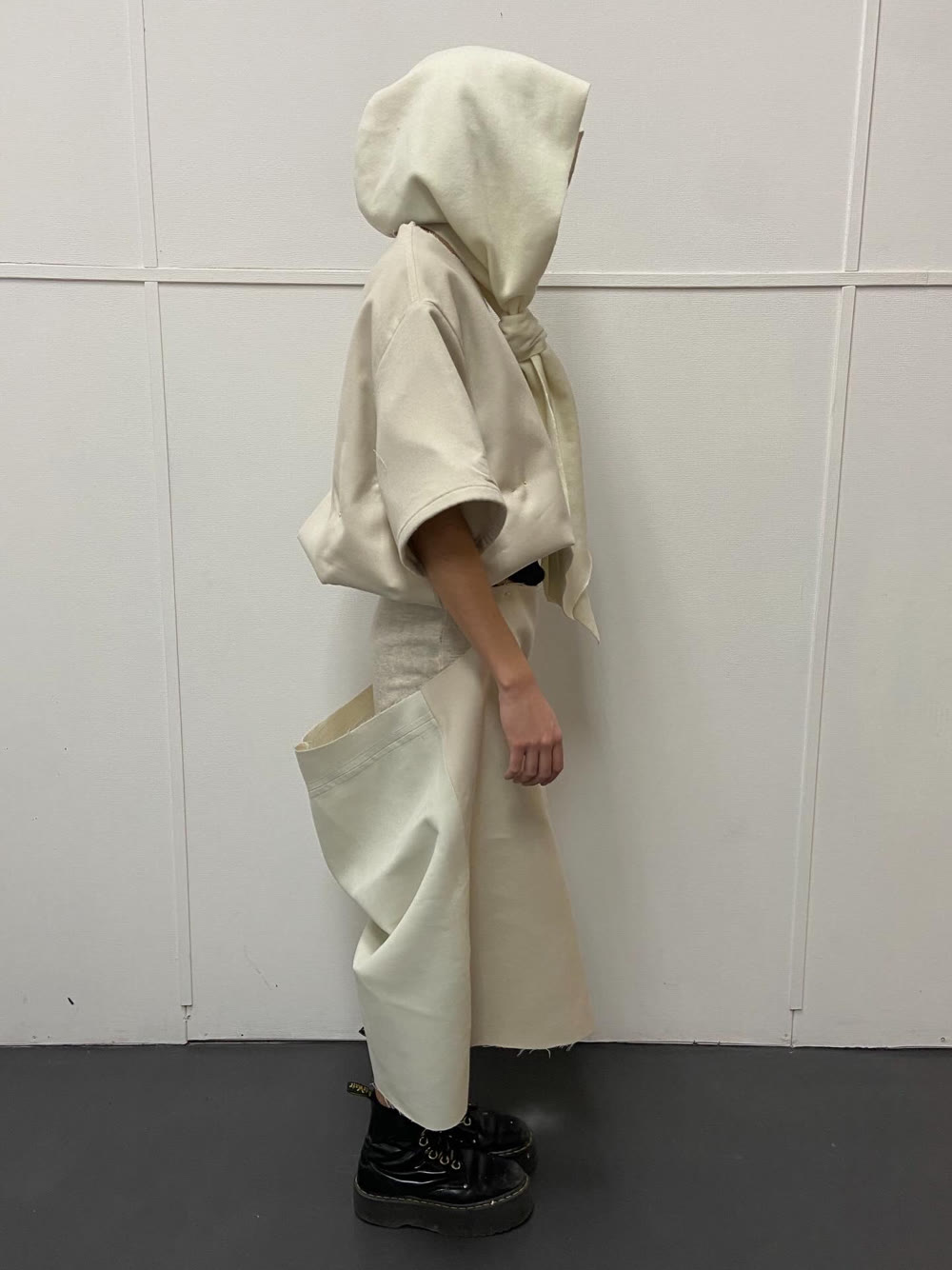 Muslin toile of the hooded look, tied and fitted on a model