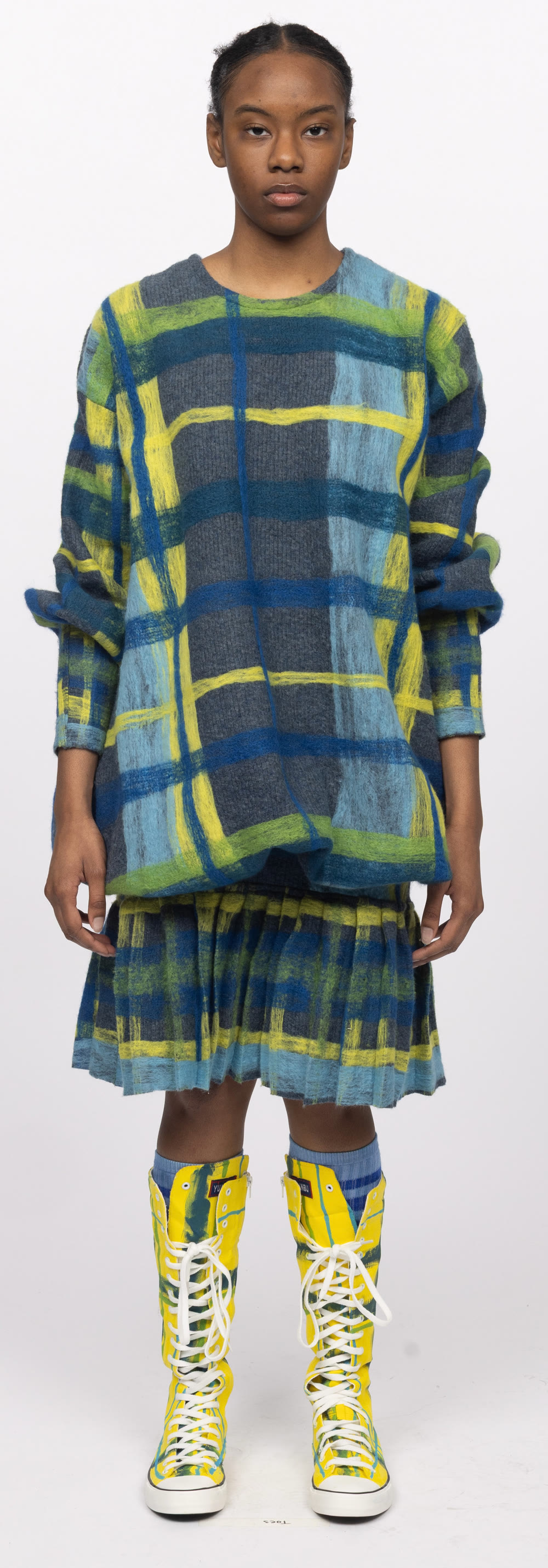 Finished look — oversized needle-felted plaid knit with pleated skirt and yellow boots