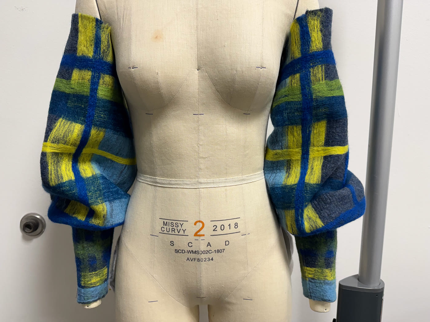 Felted plaid balloon sleeves fitted on the dress form