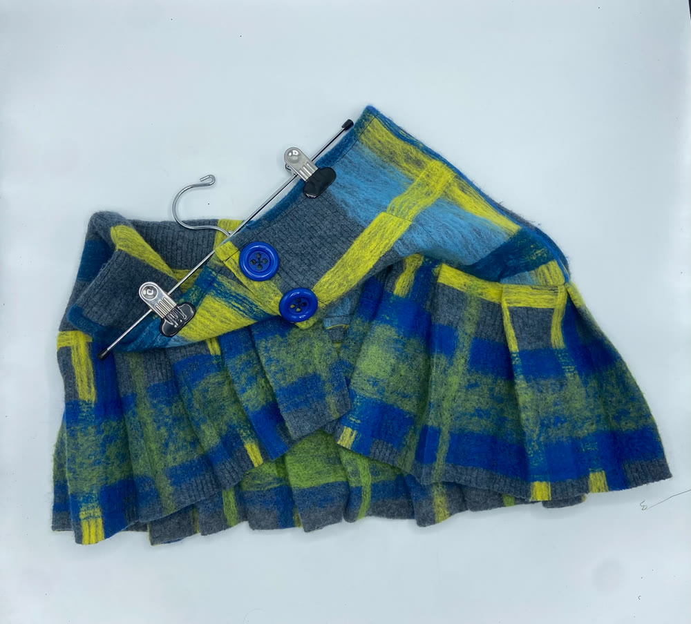 Felted plaid pleated skirt on a hanger