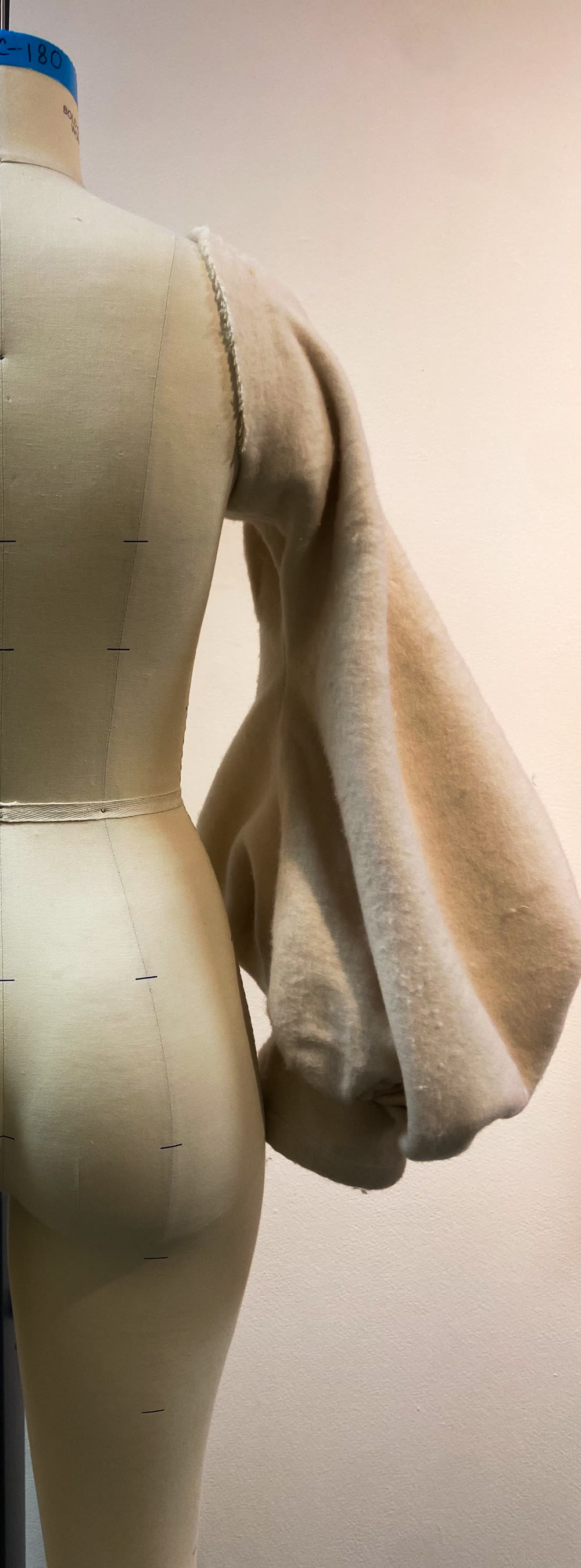 Muslin sleeve draped on a dress form